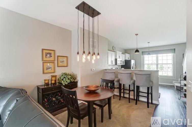 A modern dining room with a wooden table and chairs.