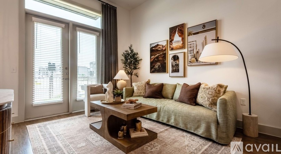 A living room with a couch, coffee table, and pictures on the wall.