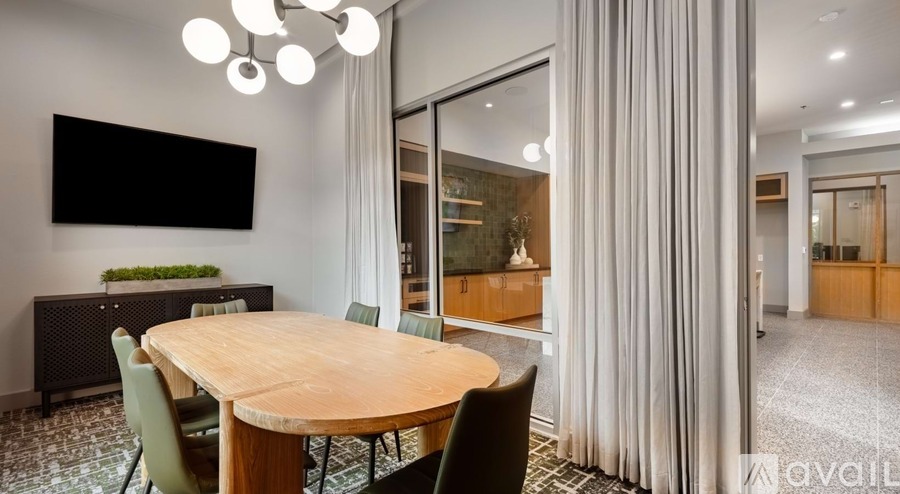 A conference room with a wooden table and chairs.