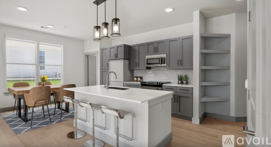 A modern kitchen with a dining table and chairs.