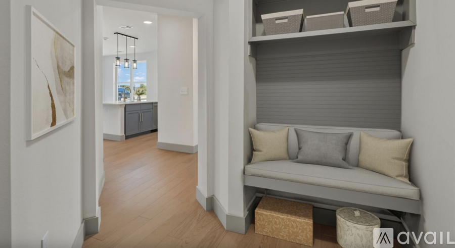 A living room with a grey sofa and a cabinet.
