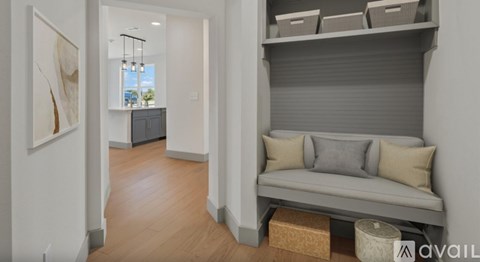 A living room with a grey sofa and a cabinet.