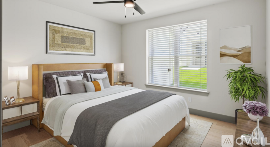 A bedroom with a large bed and a ceiling fan.