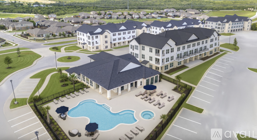 A large building with a pool in front of it.