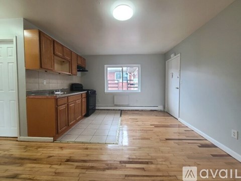 A kitchen with wooden floors and white walls.