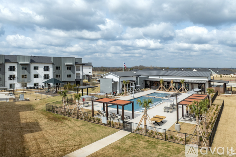 A large building with a pool in front of it.