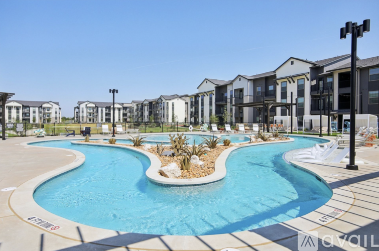 A large swimming pool in front of apartment buildings.