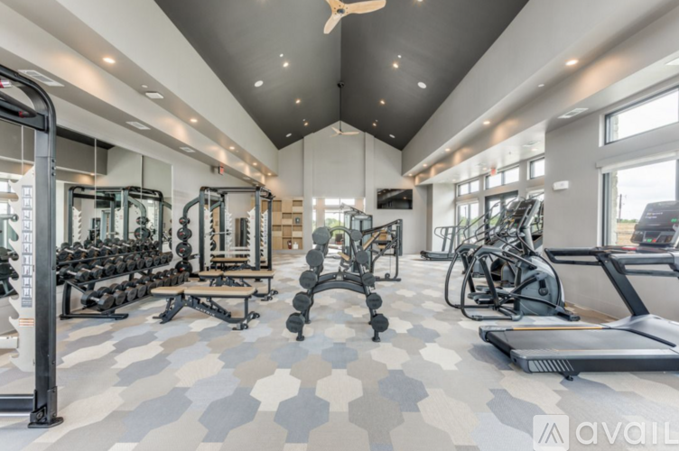 A well-equipped gym with a variety of exercise machines and weights.