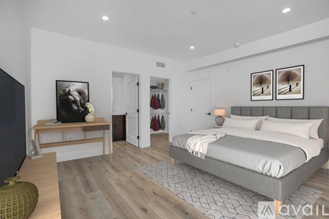 A bedroom with a large bed and a bench with a picture on it.