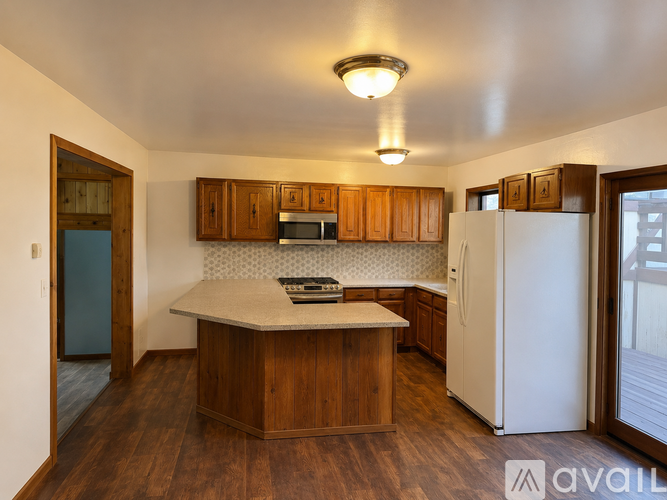 A kitchen with wooden cabinets and a white refrigerator.