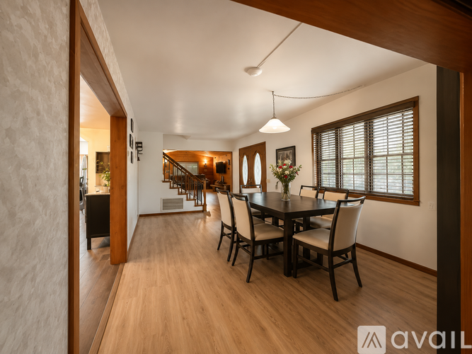 A dining room with a table set for six.
