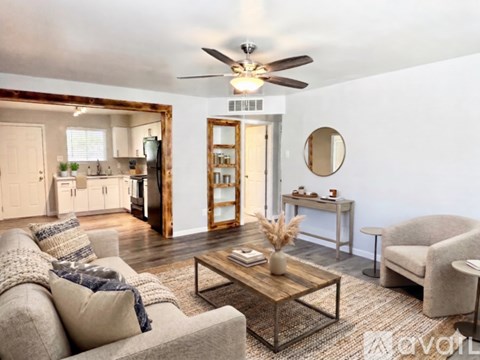 A living room with a grey couch and a wooden coffee table.