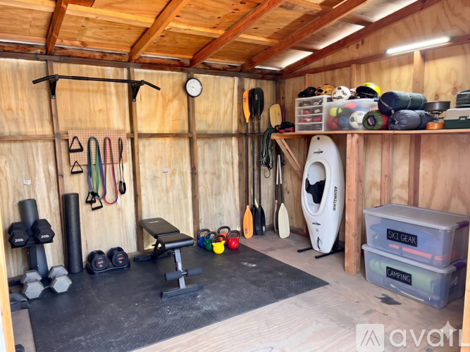 A gym room with a bench, weights, and exercise equipment.