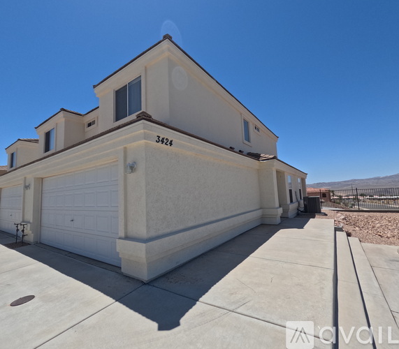 A two-story house with a garage is for sale.