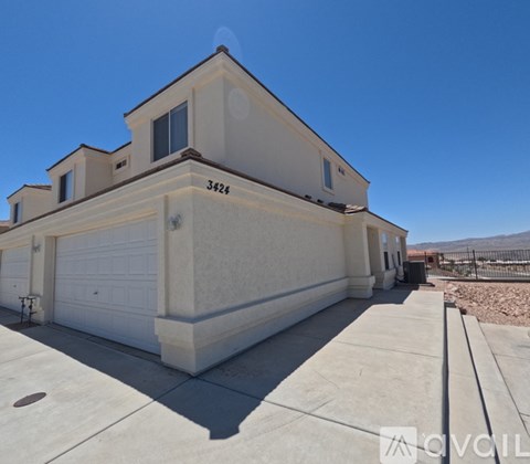 A two-story house with a garage is for sale.