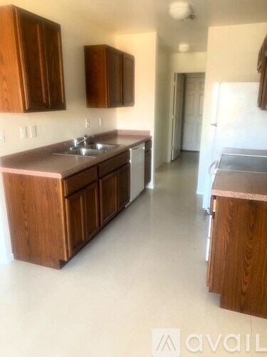A kitchen with wooden cabinets and a sink.