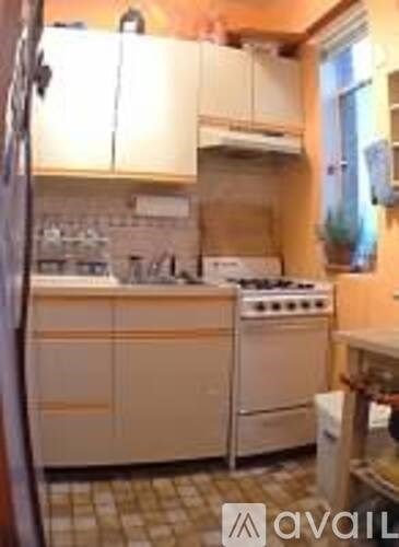 A kitchen with a stove and a refrigerator.