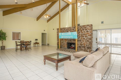 A living room with a stone fireplace and a sign that says "Welcome you residents".