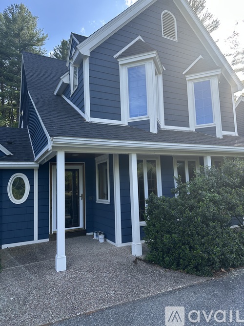 A house with a blue exterior and white trim.
