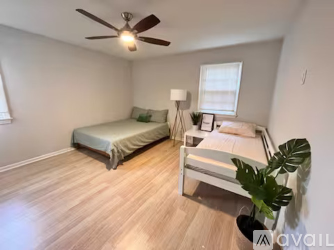 A bedroom with a bed and a bedside table.