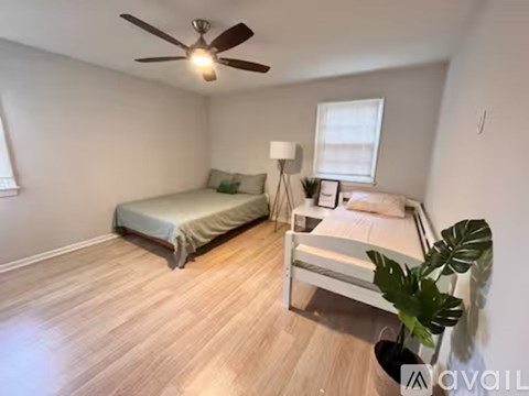 A bedroom with a bed and a bedside table.