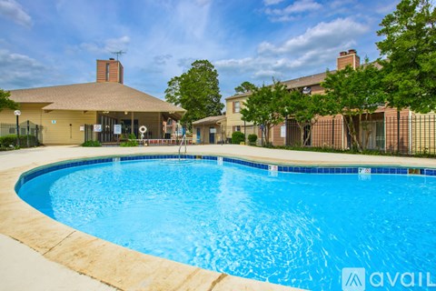 A swimming pool in front of a house with a sign that says "available".