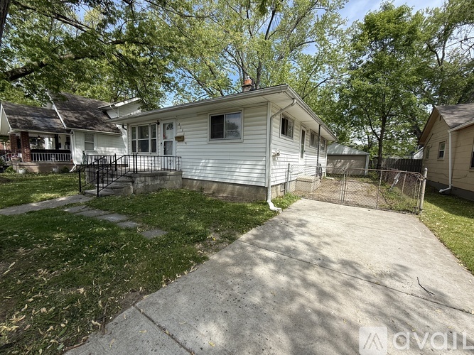 A house with a white exterior and a small front yard.