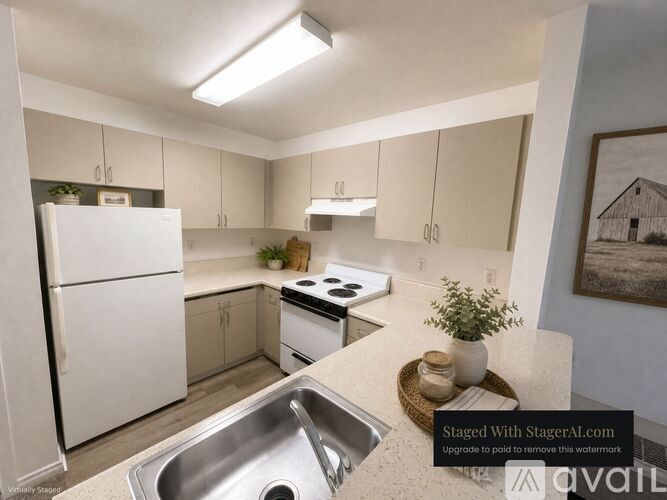 A kitchen with a white fridge, stove, and sink.