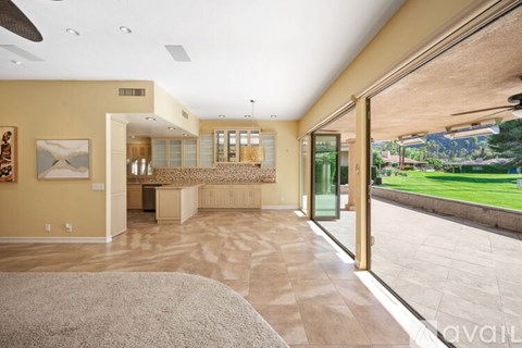 A spacious living room with a large rug on the floor.