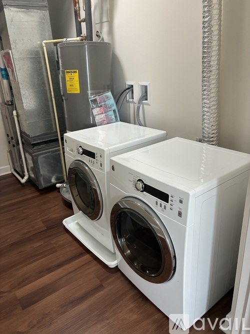 A washing machine and dryer in a laundry room.