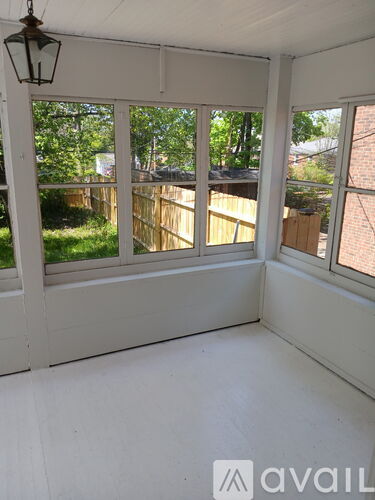 A sunny room with a view of a backyard.