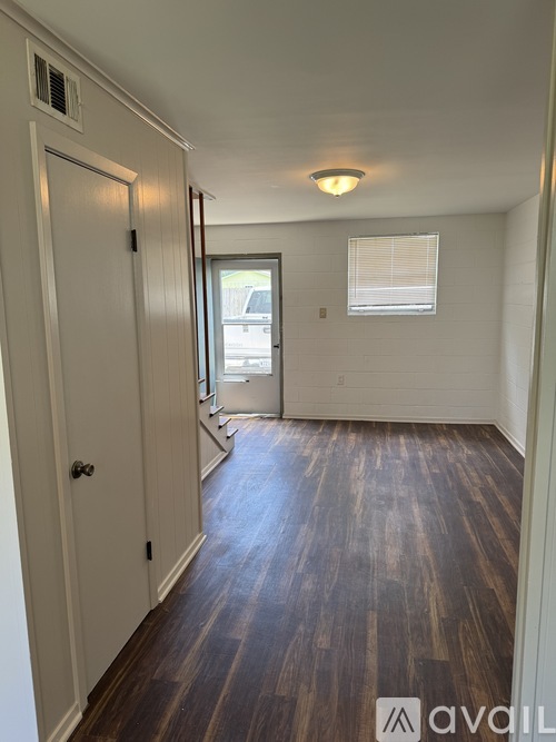 A room with wooden floors and white walls.