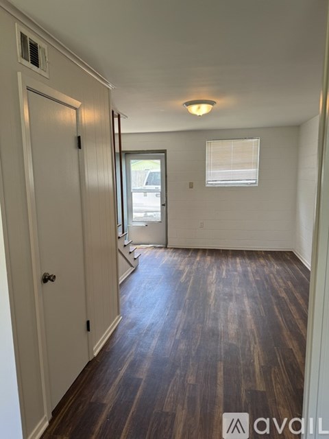 A room with wooden floors and white walls.