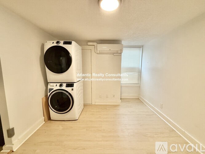 A room with a washer and dryer in it.