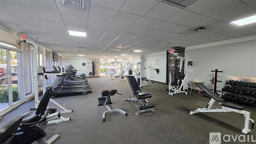 A gym with treadmills, weights, and exercise equipment.