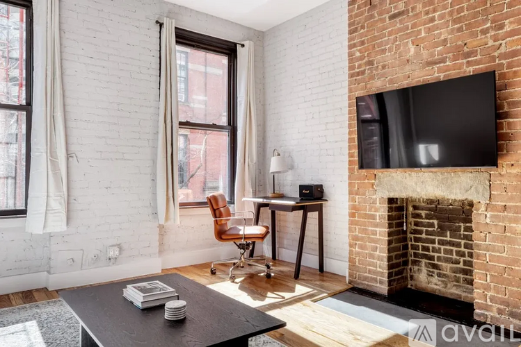 A living room with a fireplace and a television.