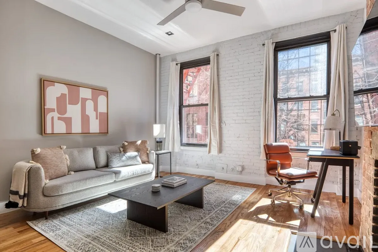 A living room with a couch, chair, and a coffee table.
