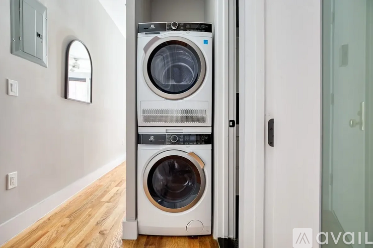 A white front loading washing machine is in a laundry room.