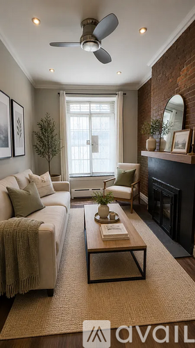A living room with a couch, a coffee table, and a fireplace.