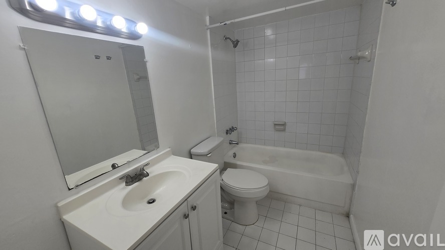 A white bathroom with a sink, toilet, and bathtub.