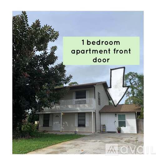 A two-story apartment building with a front door and a balcony.