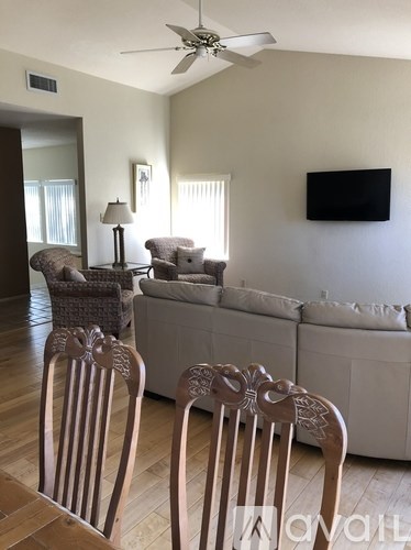 Two chairs are in the foreground of a living room.
