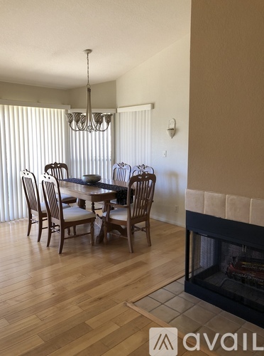 A dining room with a table and chairs.