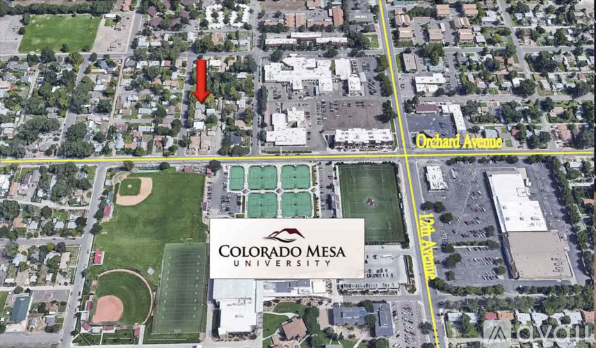 An aerial view of Colorado Mesa University with a red arrow pointing to a specific area.