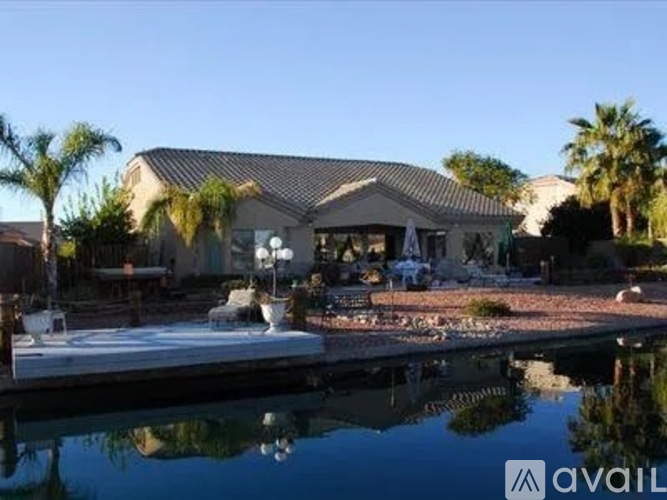 A house with a pool in front of it.