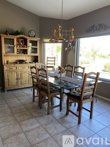 A kitchen with a table and chairs.