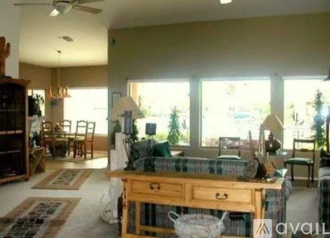 A living room with a wooden table and chairs.