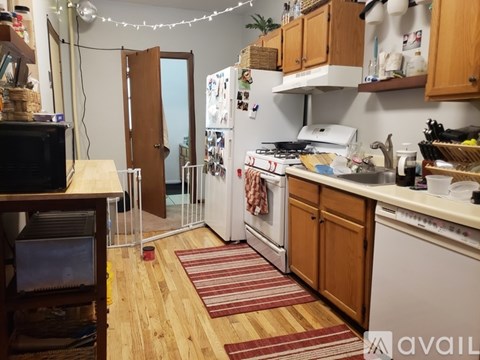 A kitchen with wooden cabinets and a white fridge.