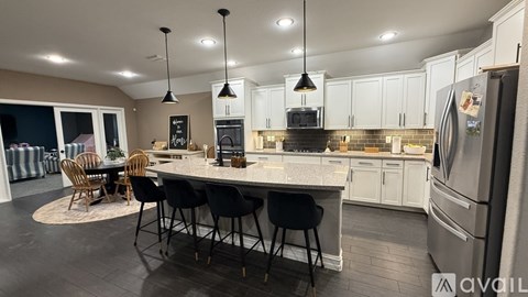 A modern kitchen with a dining table and chairs.