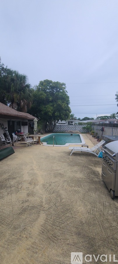 A backyard with a pool and a truck parked in the driveway.